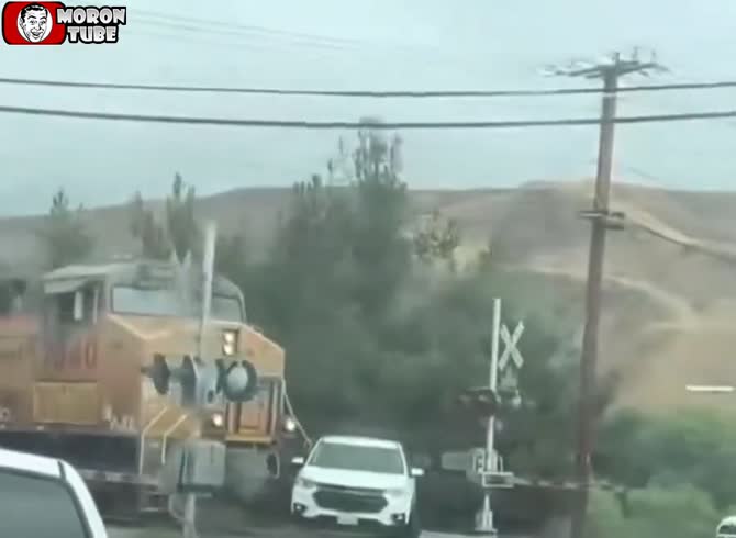 Video :As a train approaches, a brave police officer rescues a toddler from a car that has become caught on the rails